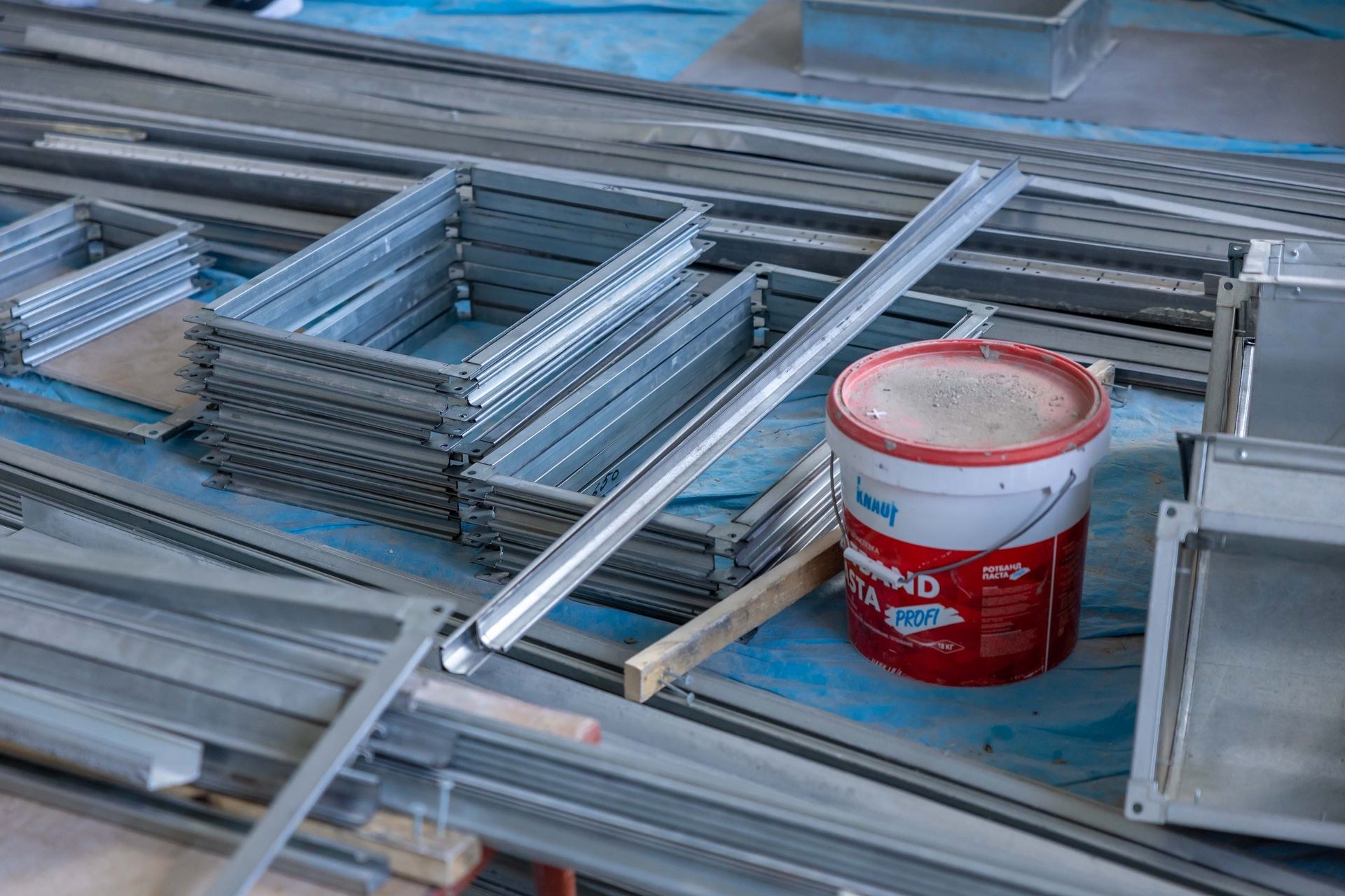 Steel frames and coating materials staged on a construction site