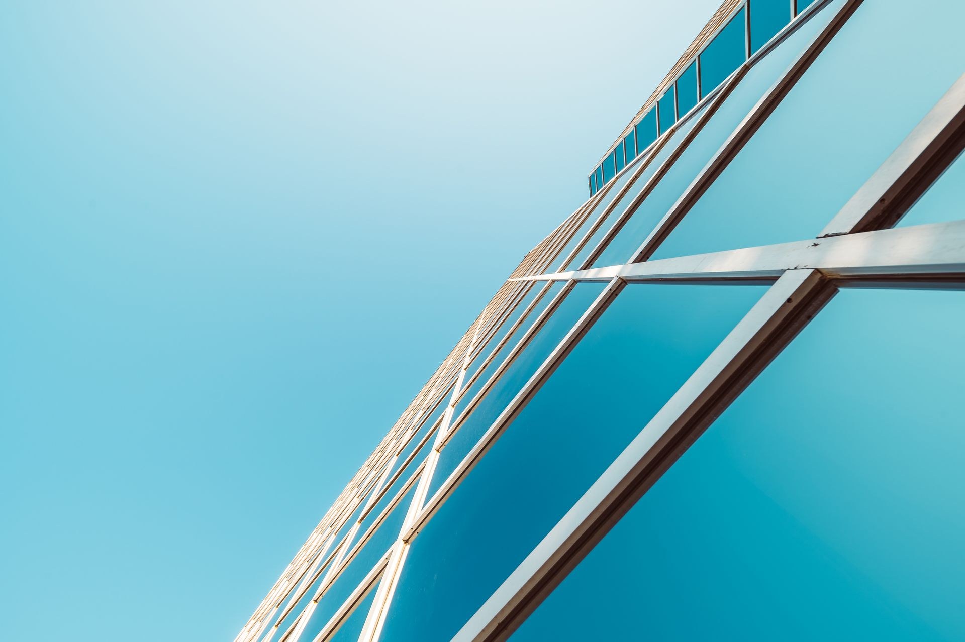 Glass-walled commercial tower representing large-scale building maintenance programmes